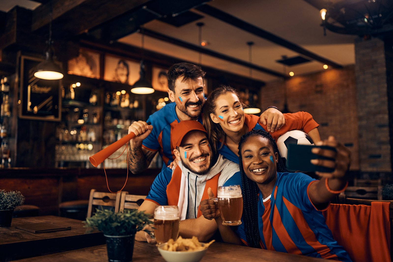 cheerful group of soccer fans taking selfie while 2024 12 13 18 17 10 utc scaled