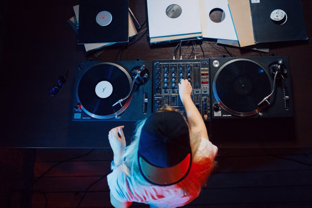 cute dj woman having fun playing music club party